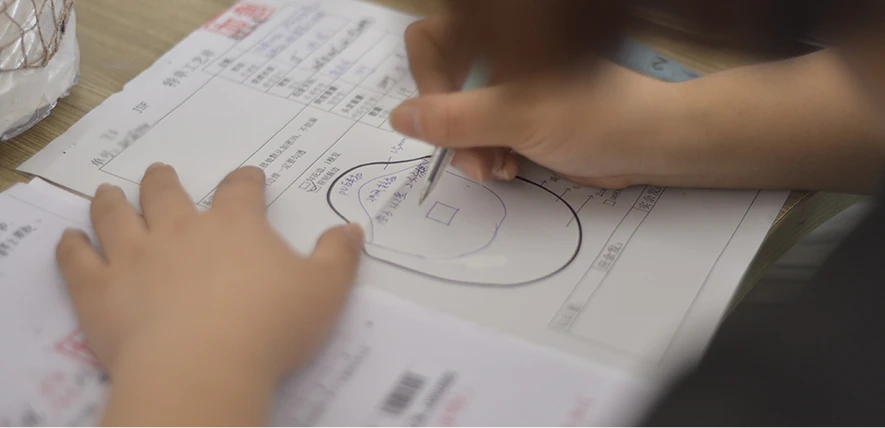 A technician designing a custom hair system base template