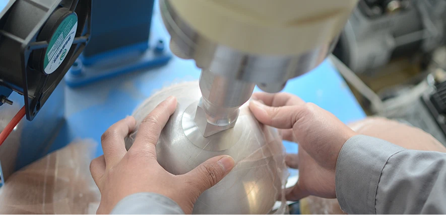 A technician pinning the lace base for a custom toupee on a specialized head mold