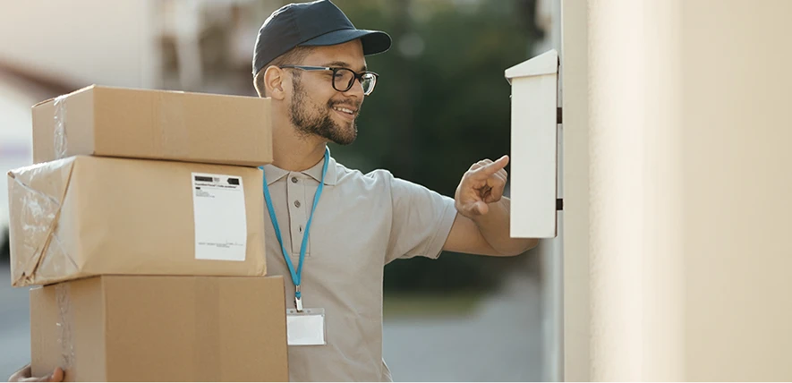 A courier delivering a packaged custom hair piece order to a client